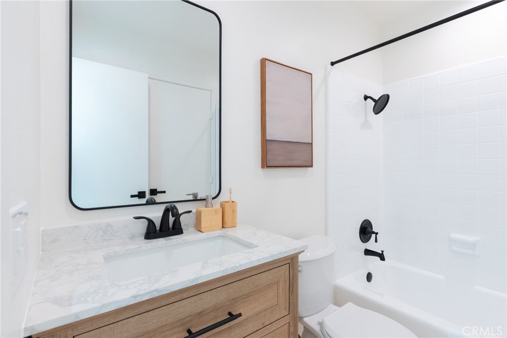 1024 West Lamark Lane Anaheim, CA 92802 - Photo 16 of 34 a bathroom with a sink a toilet and a mirror