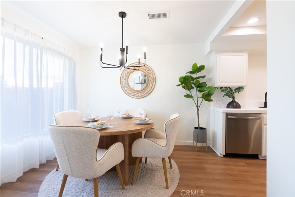 1024 West Lamark Lane Anaheim, CA 92802 - Photo 4 of 34 a dining room with furniture potted plants and wooden floor