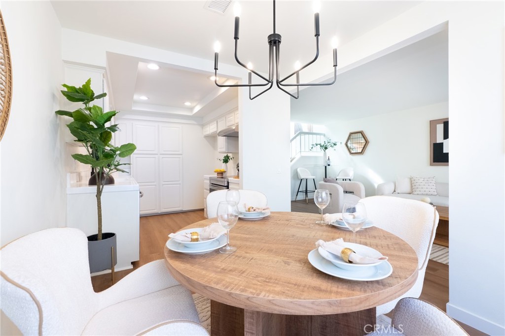 1024 West Lamark Lane Anaheim, CA 92802 - Photo 5 of 34 a view of a dining room with furniture a chandelier and wooden floor