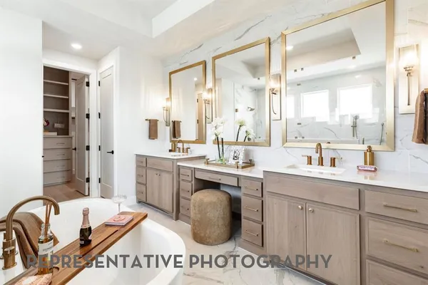 a spacious bathroom with a sink a mirror a bathtub and shower