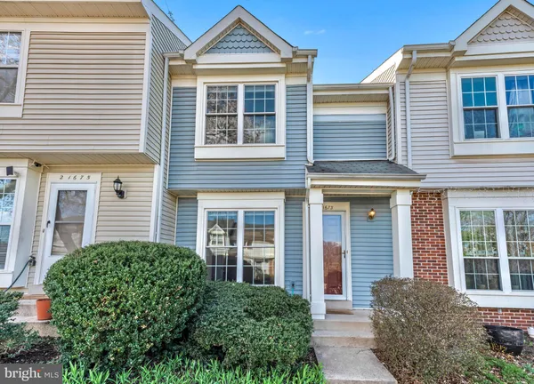 front view of a brick house with large windows