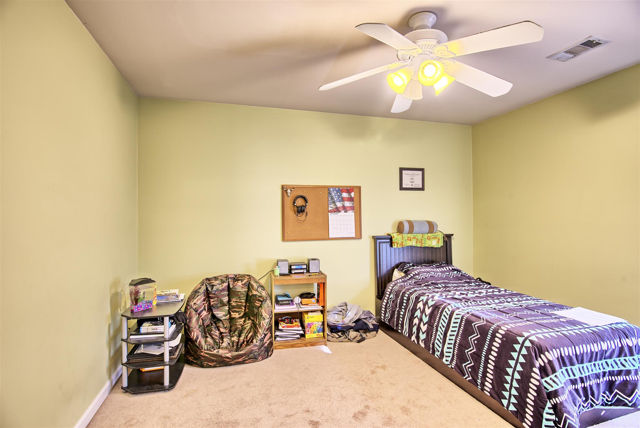 7511 Cherokee Hills Road Fairview, TN 37062 - Photo 16 of 18 a bedroom with a bed and a chandelier