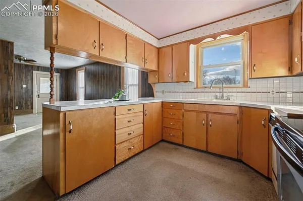 a kitchen with granite countertop cabinets stainless steel appliances and a sink