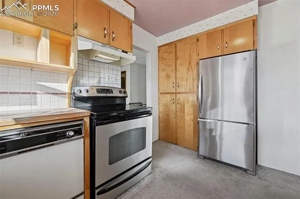 a kitchen with a refrigerator stove and microwave