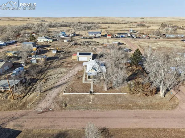 an aerial view of residential houses with outdoor space
