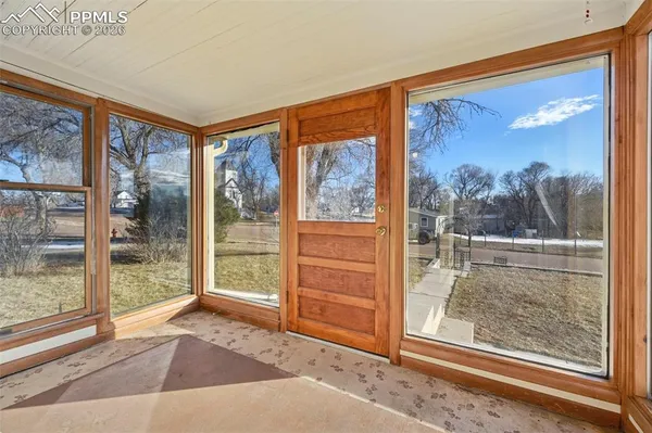 a view of a room with a door and a window