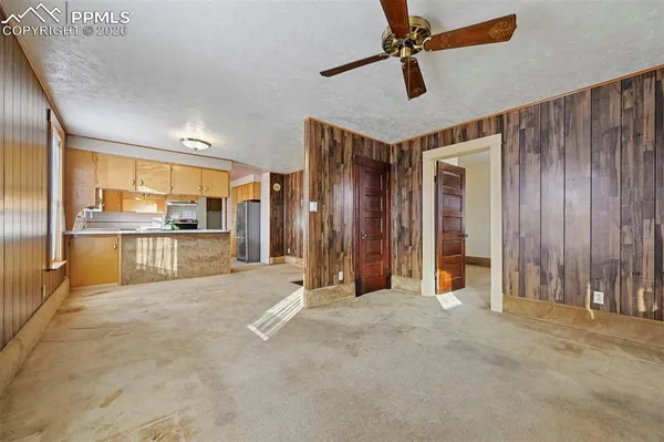 a view of a kitchen with stainless steel appliances granite countertop cabinets and a window