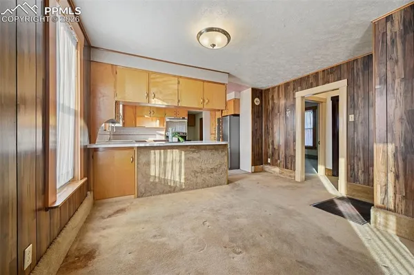 a view of a kitchen with a sink and cabinets