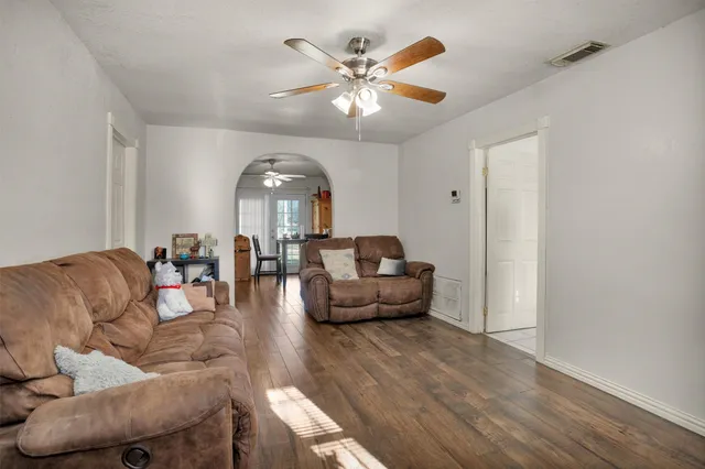 a living room with furniture and a chandelier