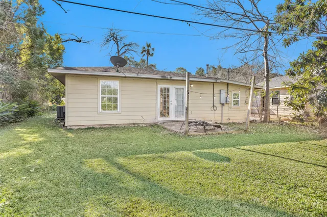 a view of a backyard with large trees