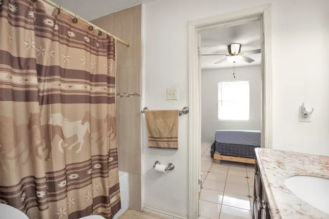 a bathroom with a bathtub and shower