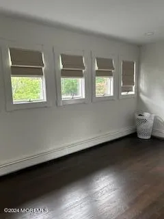a view of a room with two windows