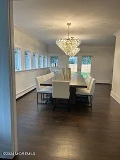 a view of a dining room with furniture and chandelier