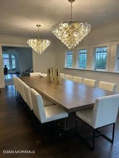 a view of a dining room with furniture and chandelier