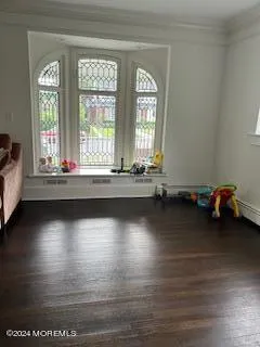 a view of a room with wooden floor and a window