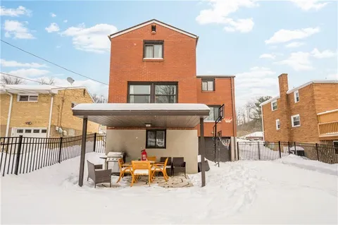 a front view of a house with sitting area