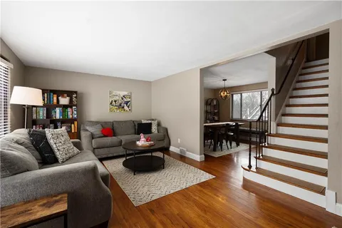 a living room with furniture and wooden floor