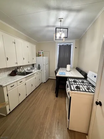 a kitchen with stainless steel appliances granite countertop a stove a sink dishwasher and a refrigerator