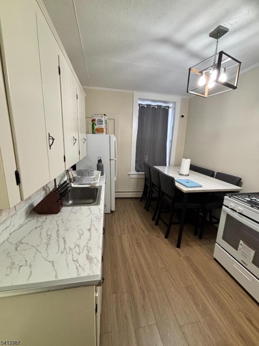 16 Woodland Avenue, Unit 4 Butler, NJ 07405 - Photo 13 of 19 a living room with furniture and a wooden floor
