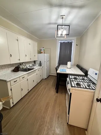 a kitchen with a stove and a refrigerator