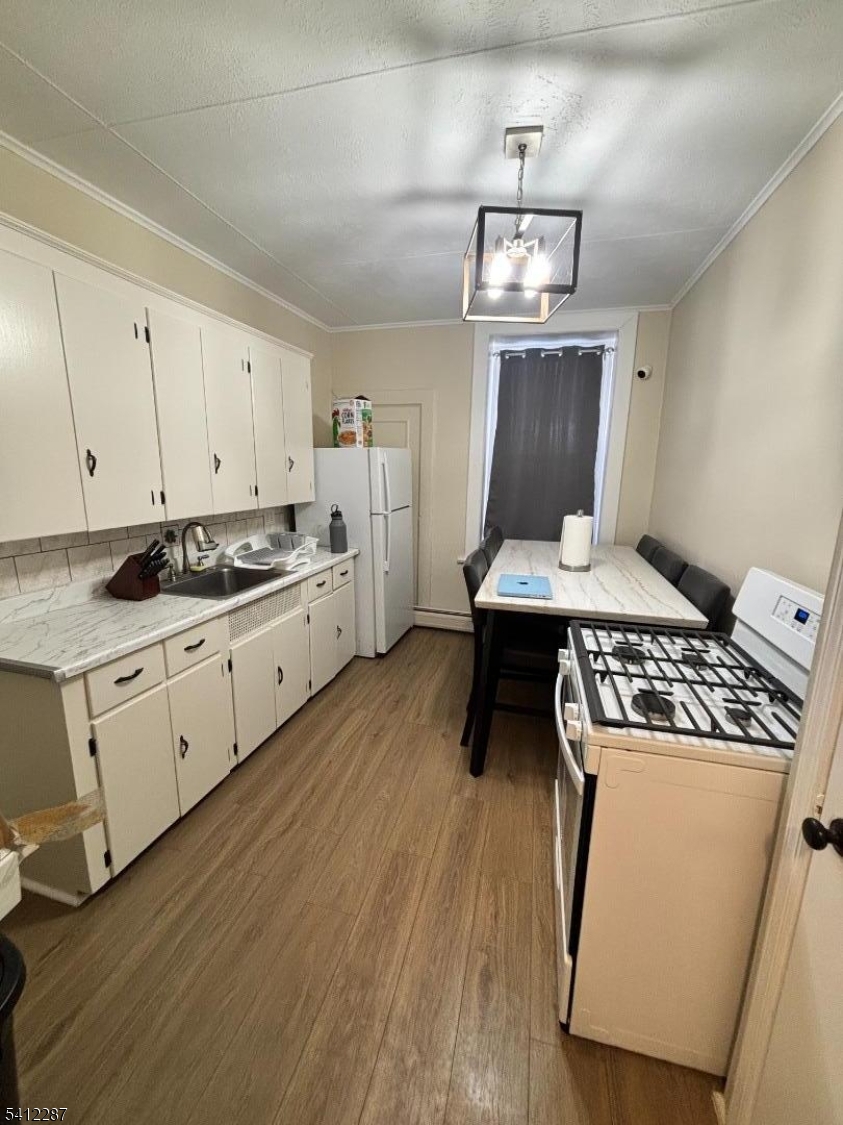 16 Woodland Avenue, Unit 4 Butler, NJ 07405 - Photo 14 of 19 a kitchen with a stove and a refrigerator