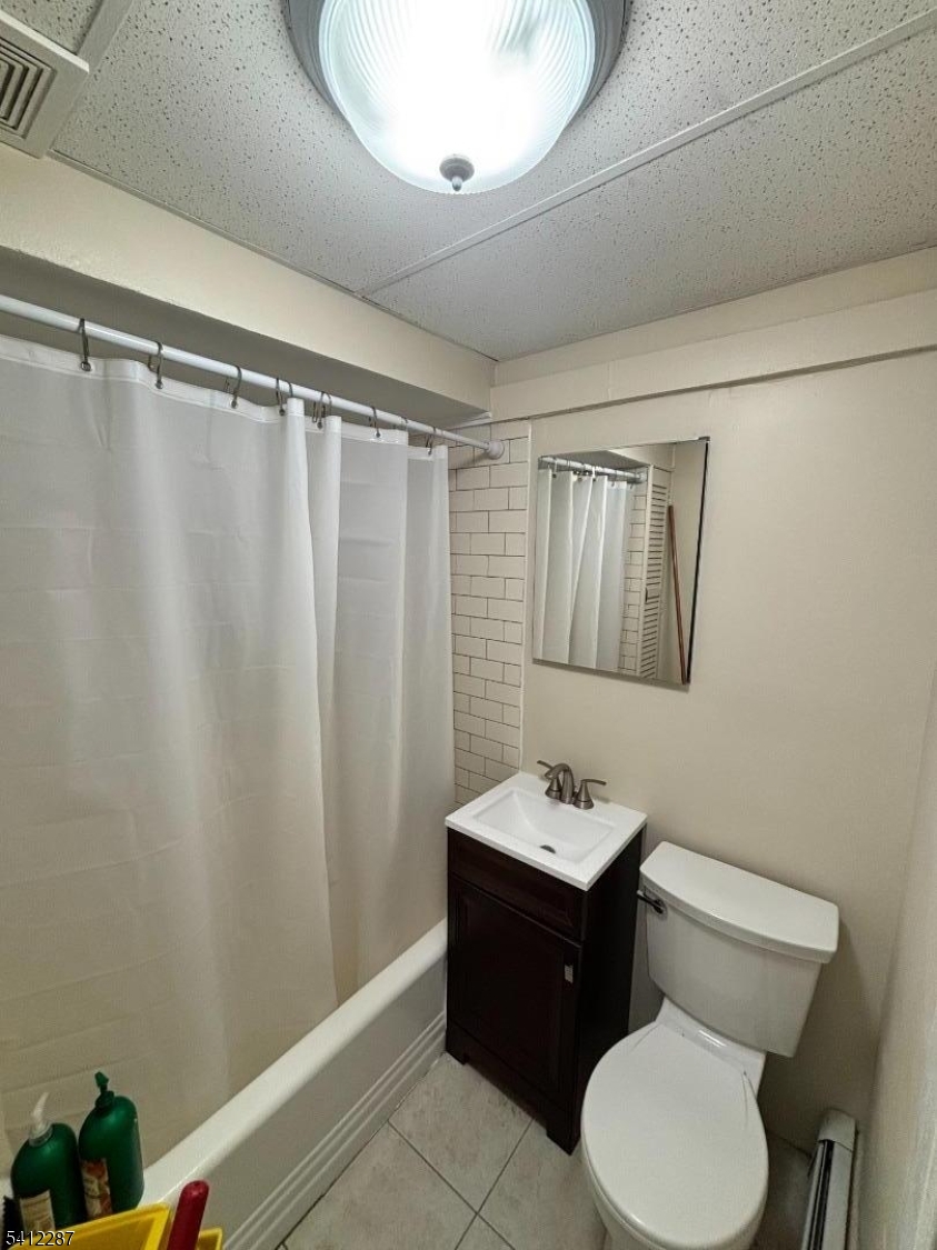16 Woodland Avenue, Unit 4 Butler, NJ 07405 - Photo 15 of 19 a bathroom with a sink vanity mirror and toilet
