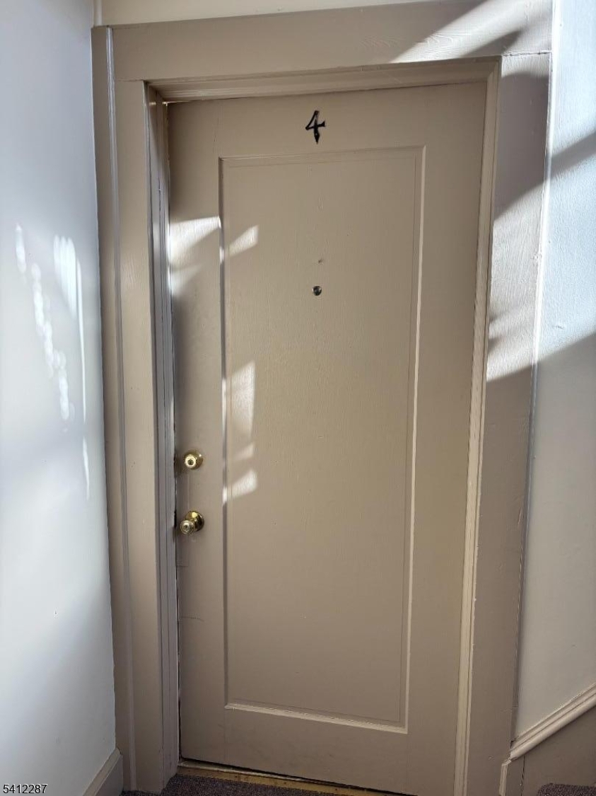 16 Woodland Avenue, Unit 4 Butler, NJ 07405 - Photo 3 of 19 a bathroom with a glass shower door