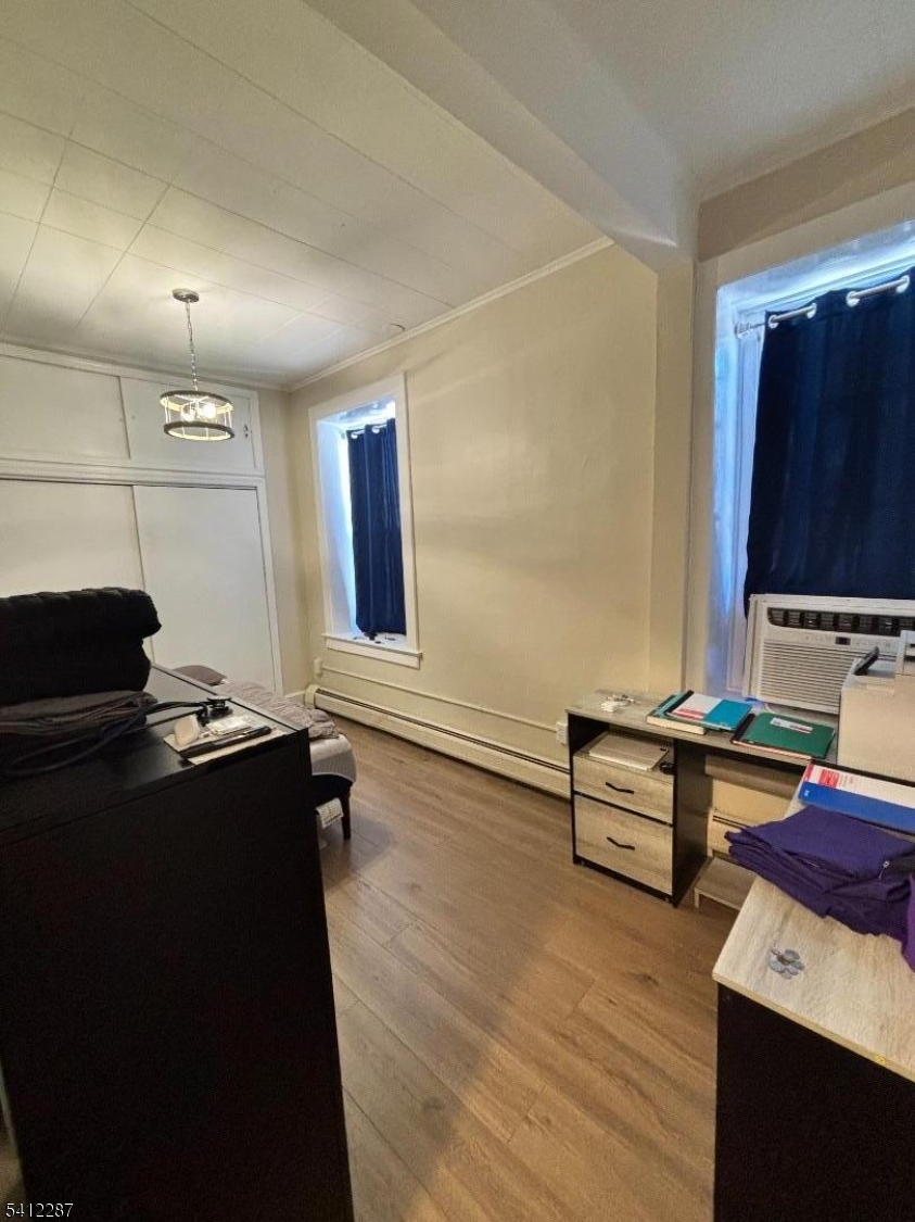 16 Woodland Avenue, Unit 4 Butler, NJ 07405 - Photo 9 of 19 a kitchen with a sink and wooden cabinets