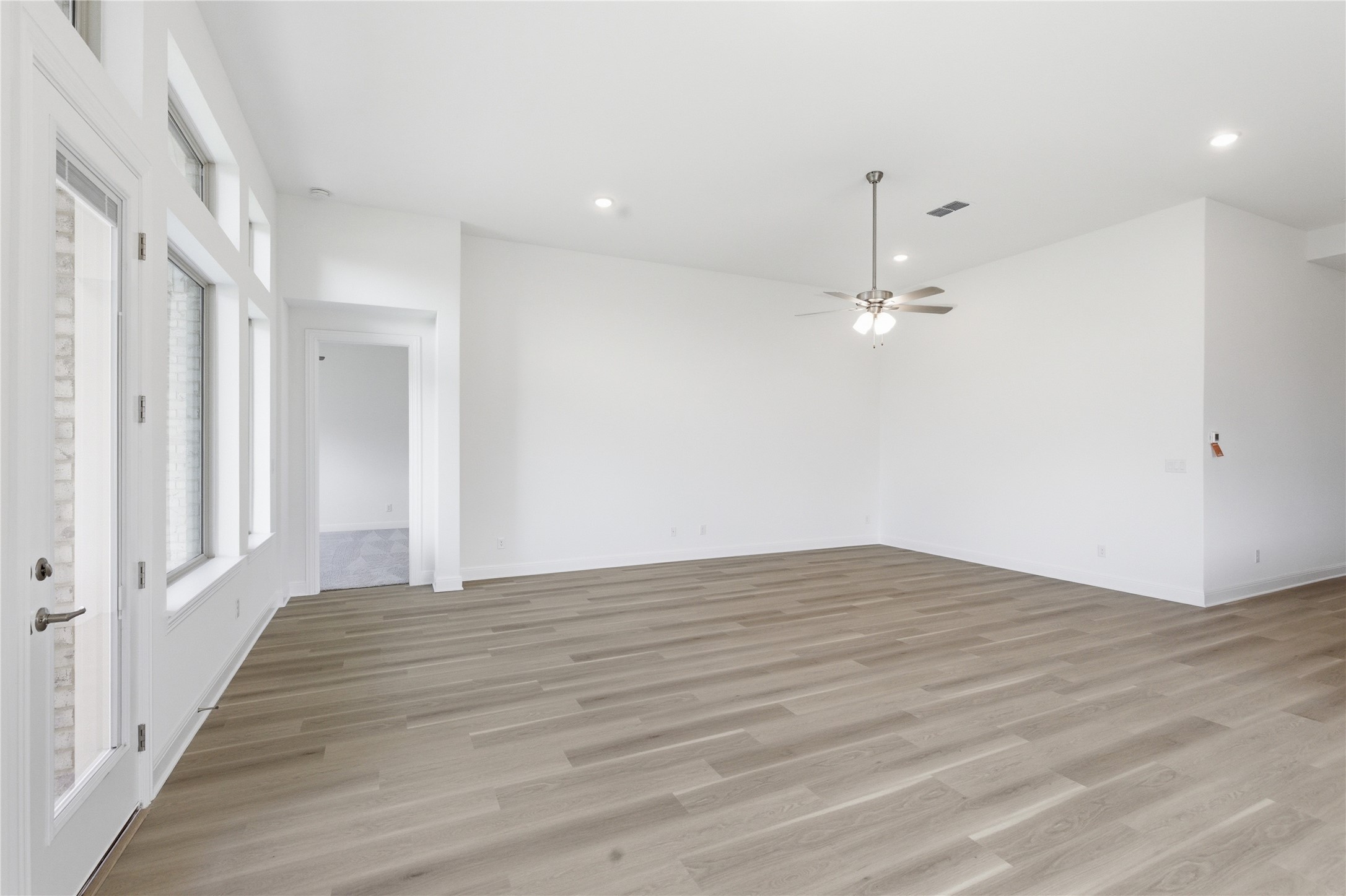 101 Lost Treasure Terrace Georgetown, TX 78628 - Photo 11 of 32 wooden floor in an empty room with a window