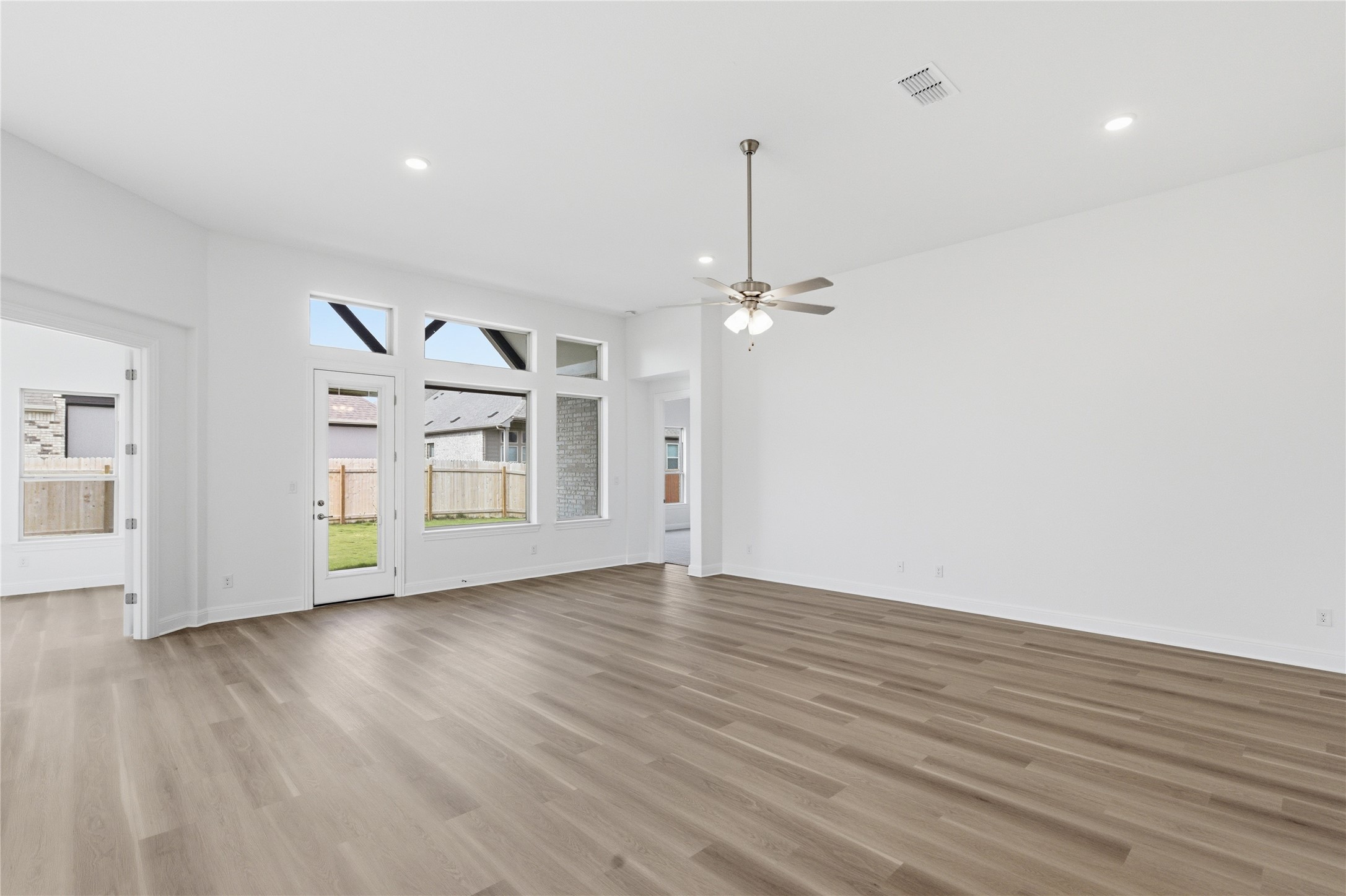 101 Lost Treasure Terrace Georgetown, TX 78628 - Photo 12 of 32 a view of an empty room with window and wooden floor
