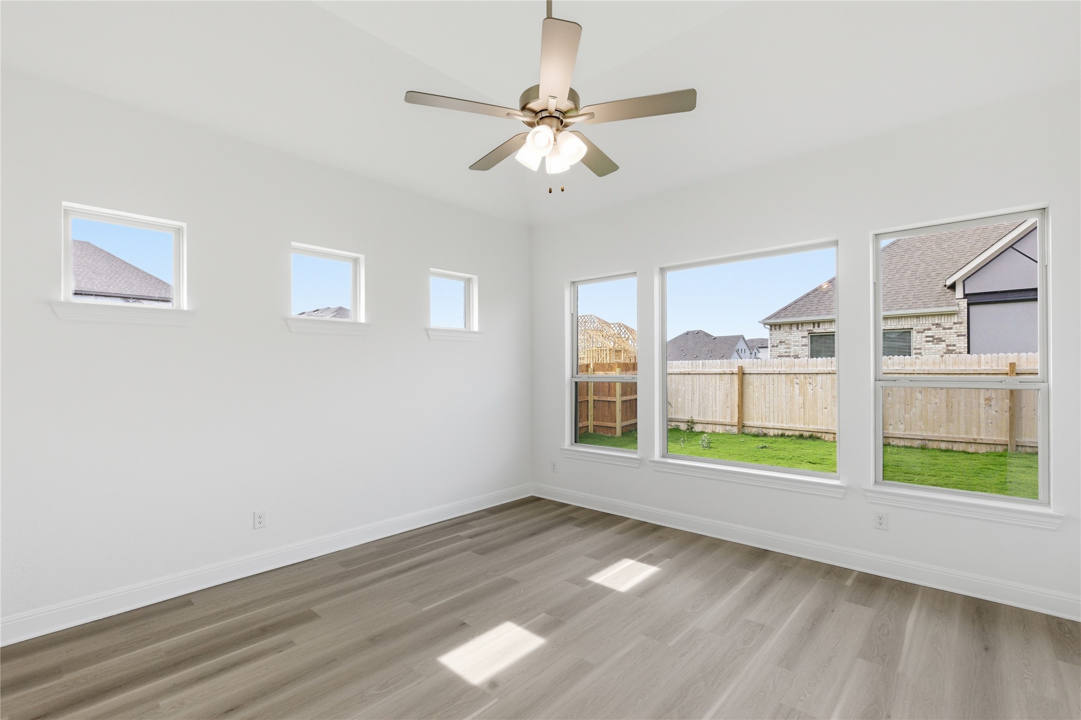 101 Lost Treasure Terrace Georgetown, TX 78628 - Photo 13 of 32 a view of an empty room with a window and wooden floor