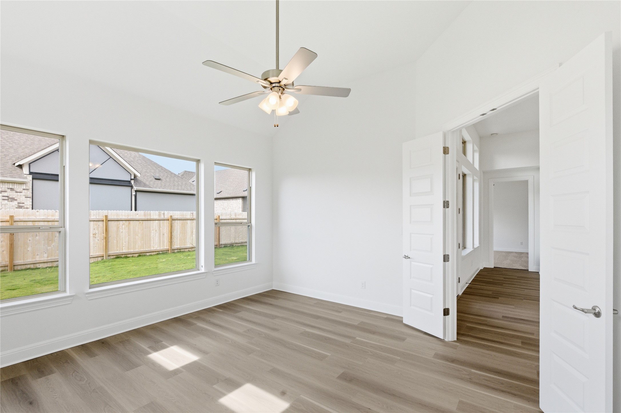 101 Lost Treasure Terrace Georgetown, TX 78628 - Photo 14 of 32 a view of an empty room with a window and wooden floor