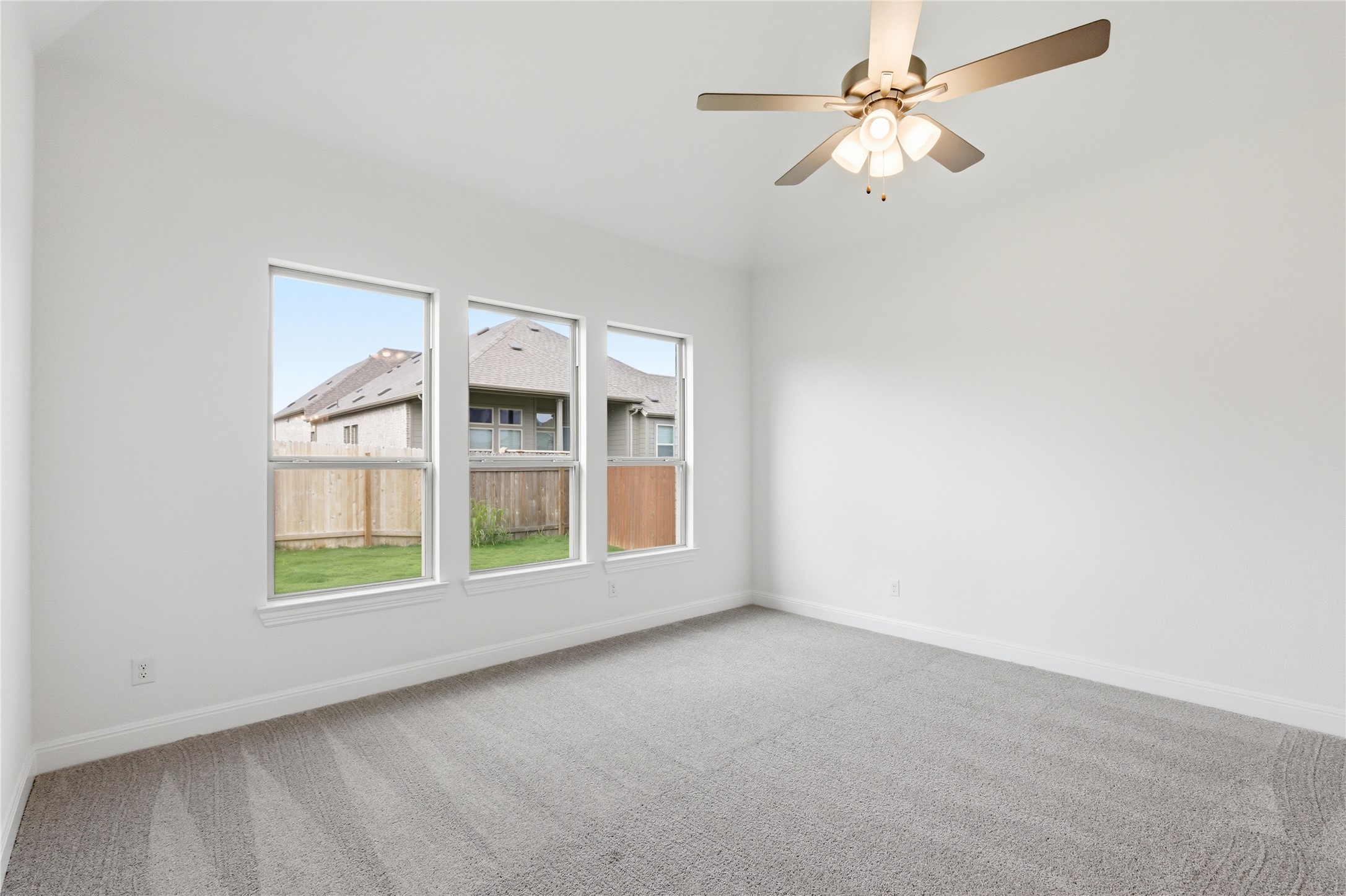 101 Lost Treasure Terrace Georgetown, TX 78628 - Photo 17 of 32 an empty room with windows and fan
