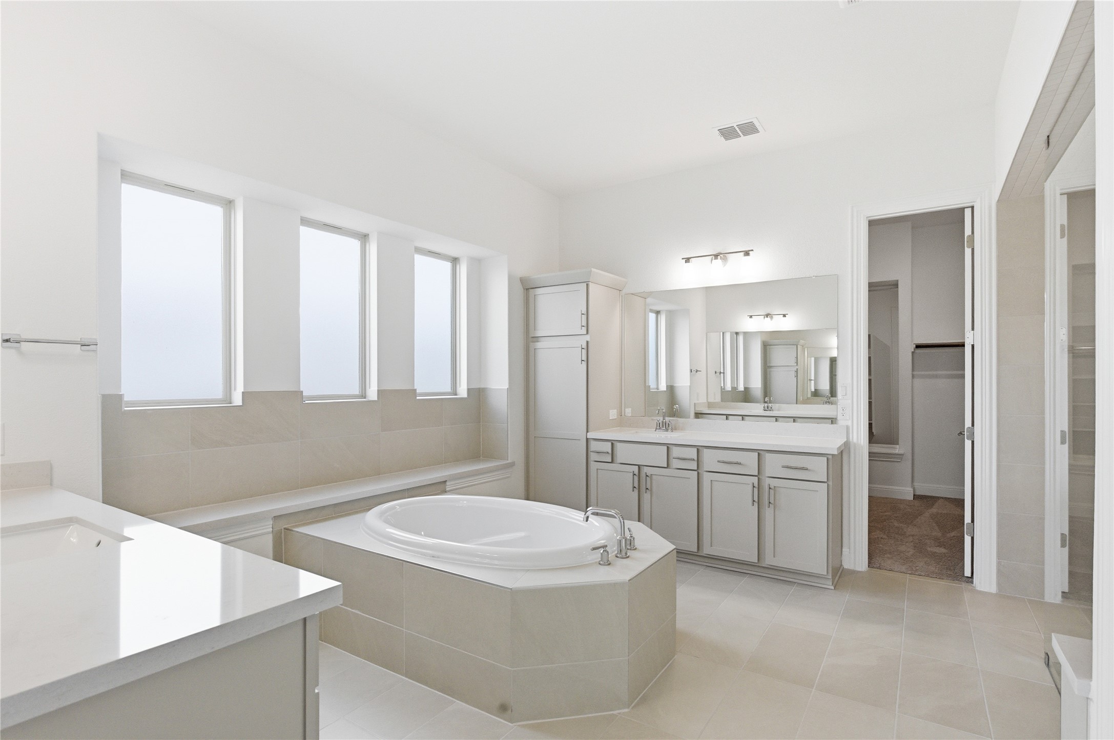 101 Lost Treasure Terrace Georgetown, TX 78628 - Photo 19 of 32 a bathroom with a granite countertop sink mirror vanity and bathtub