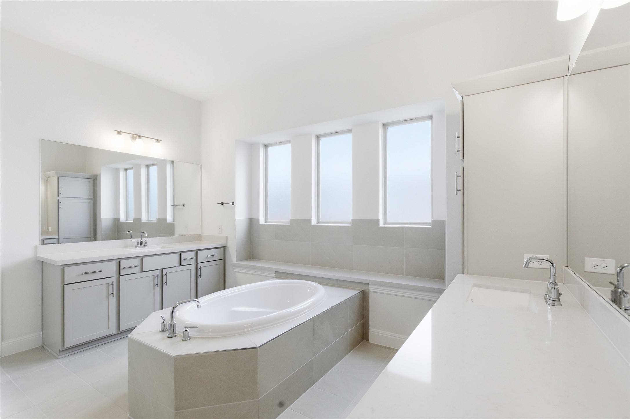 101 Lost Treasure Terrace Georgetown, TX 78628 - Photo 20 of 32 a bathroom with a granite countertop sink and a bathtub