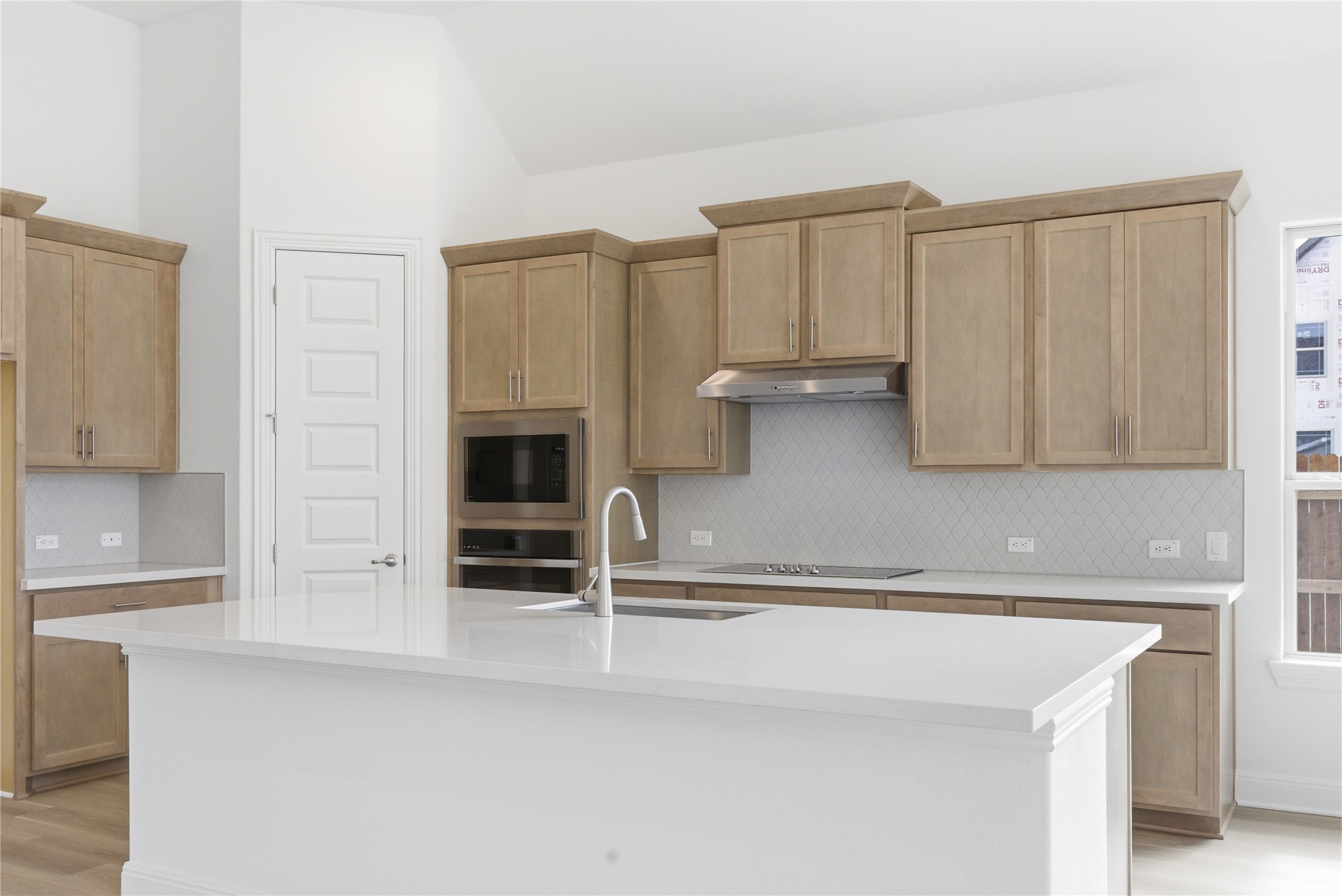 101 Lost Treasure Terrace Georgetown, TX 78628 - Photo 4 of 32 a kitchen with stainless steel appliances a refrigerator and cabinets