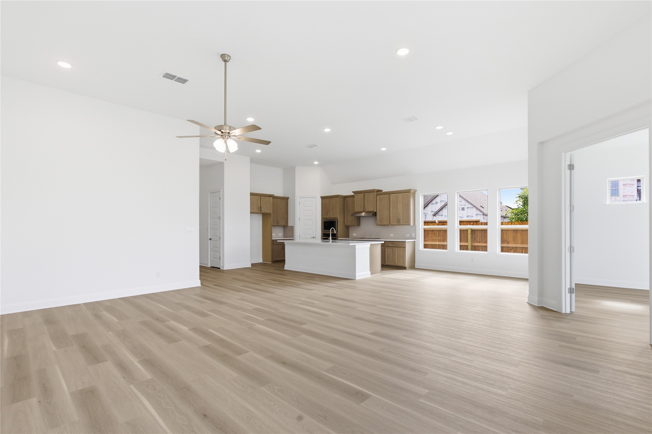 101 Lost Treasure Terrace Georgetown, TX 78628 - Photo 9 of 32 a view of a big room with wooden floor and windows
