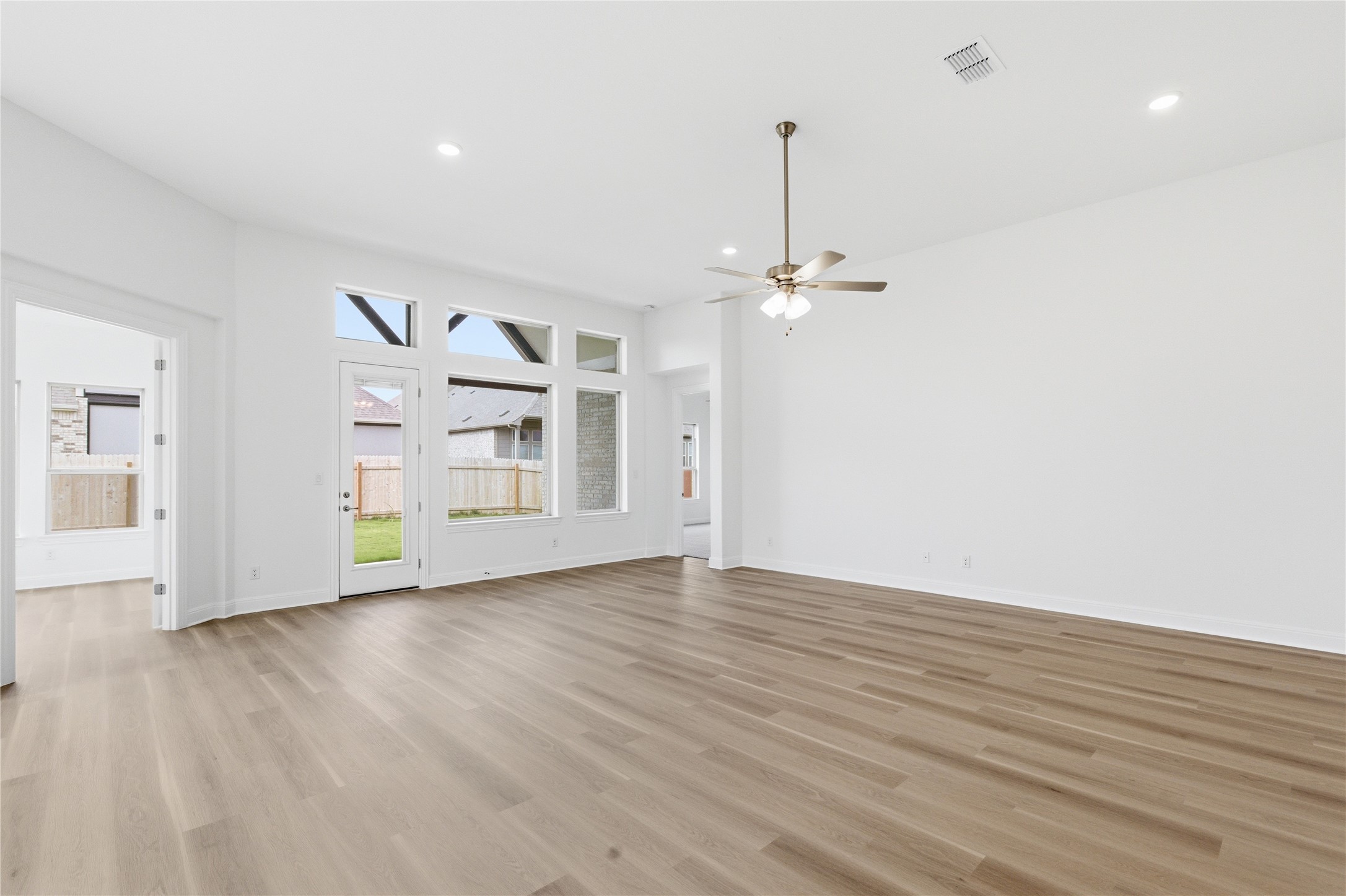 101 Lost Treasure Terrace Georgetown, TX 78628 - Photo 10 of 32 a view of an empty room with a window and wooden floor