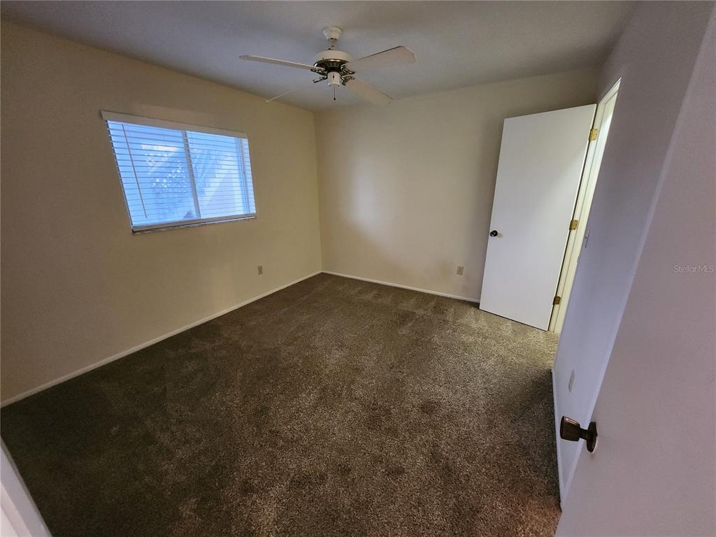 6800 Placida Road, Unit 1004 Englewood, FL 34224 - Photo 13 of 26 an empty room with windows and fan