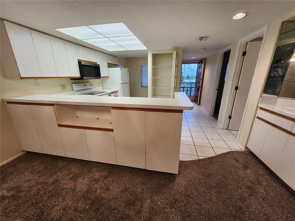 6800 Placida Road, Unit 1004 Englewood, FL 34224 - Photo 3 of 26 a open kitchen with cabinets stove and sink