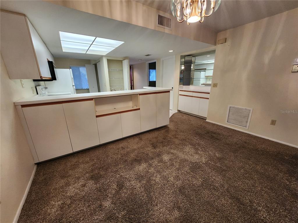 6800 Placida Road, Unit 1004 Englewood, FL 34224 - Photo 7 of 26 a view of a kitchen with a sink and mirror