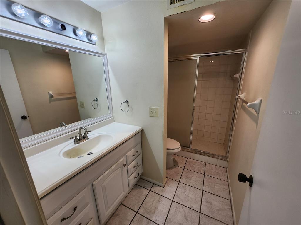 6800 Placida Road, Unit 1004 Englewood, FL 34224 - Photo 10 of 26 a bathroom with a sink a toilet and shower