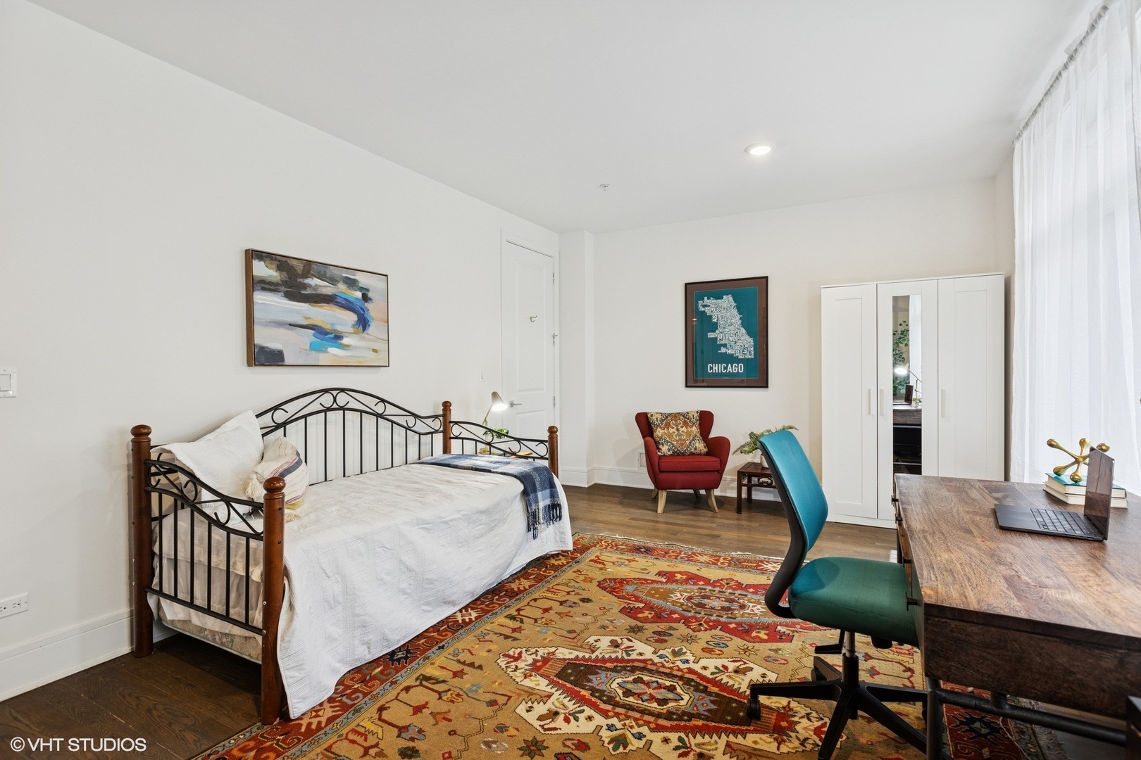 5748 North Hermitage Avenue, Unit 102 Chicago, IL 60660 - Photo 12 of 34 a bedroom with furniture and a wooden floor