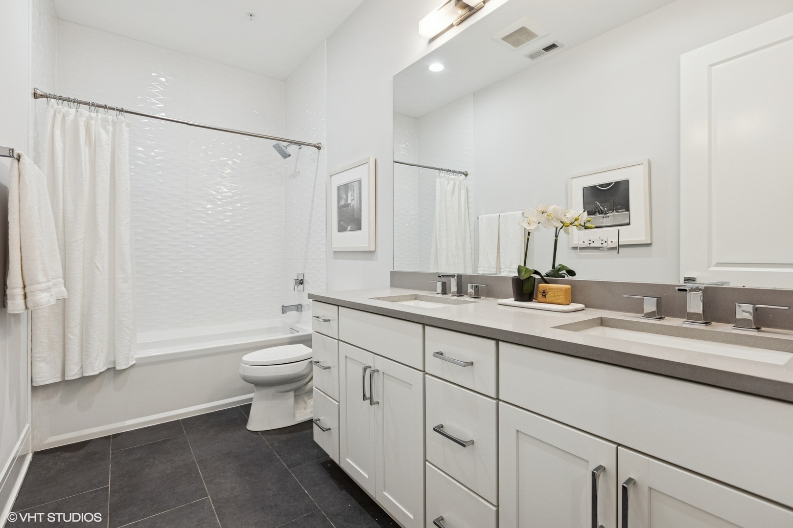 5748 North Hermitage Avenue, Unit 102 Chicago, IL 60660 - Photo 21 of 34 a bathroom with a double vanity sink toilet mirror and shower