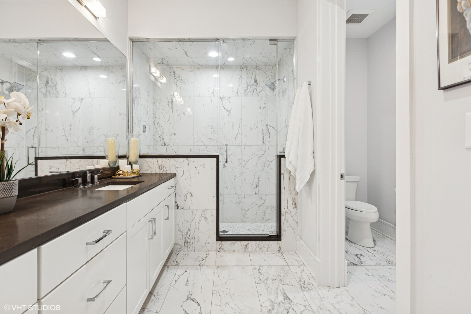 5748 North Hermitage Avenue, Unit 102 Chicago, IL 60660 - Photo 27 of 34 a spacious bathroom with a granite countertop sink a toilet and a shower