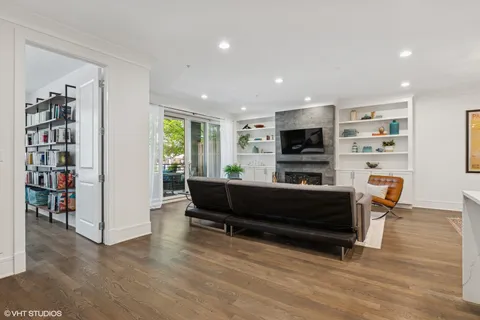 a living room with furniture flat screen tv and a fireplace