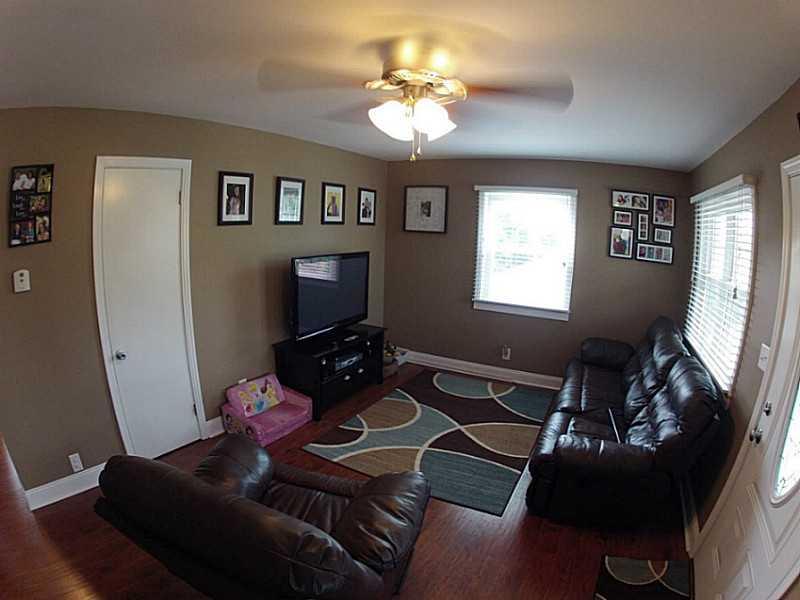29 Ewing Road McKees Rocks, PA 15136 - Photo 4 of 24 Living Room. Ceiling fan, new windows, interior doors, trim throughout