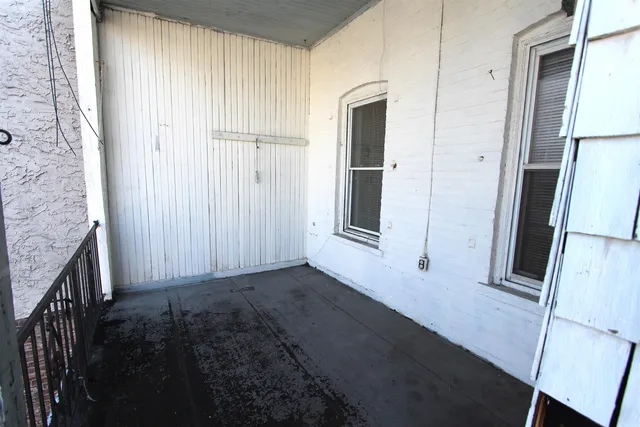 a view of a hallway with a wooden door