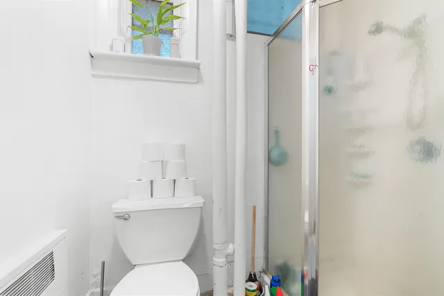 a bathroom with a toilet a sink and a window