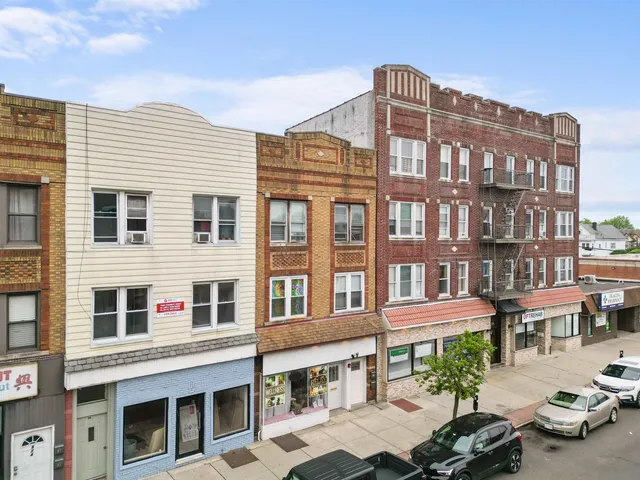 a front view of a residential apartment building with a yard